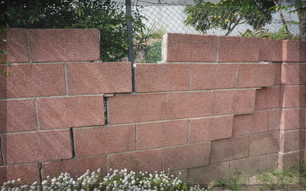 Separating block wall, requires repair from a mason