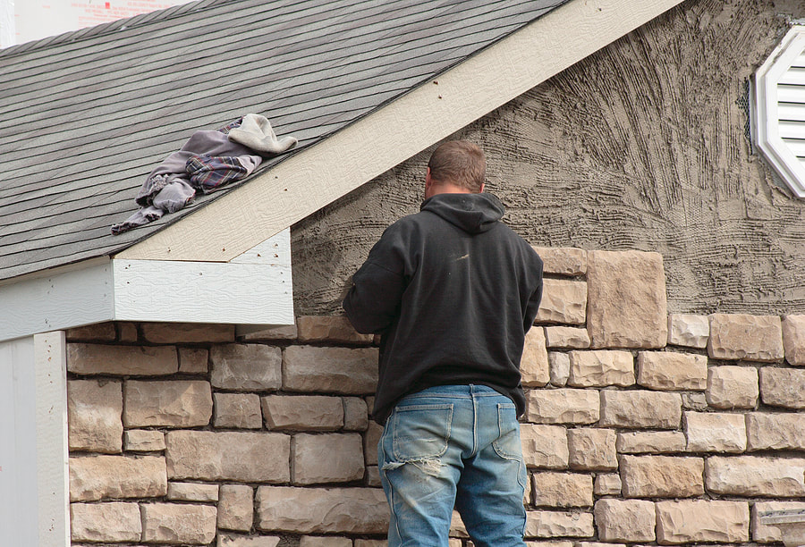 man doing wall repair